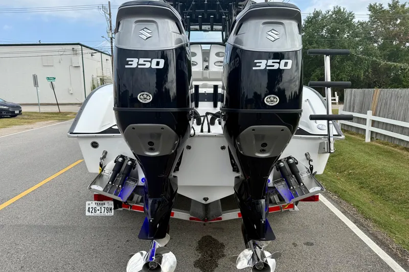 Slide: The Image of 2022 Cape Horn 31 T boat with Suzuki engine on calm water near residential area. - 3