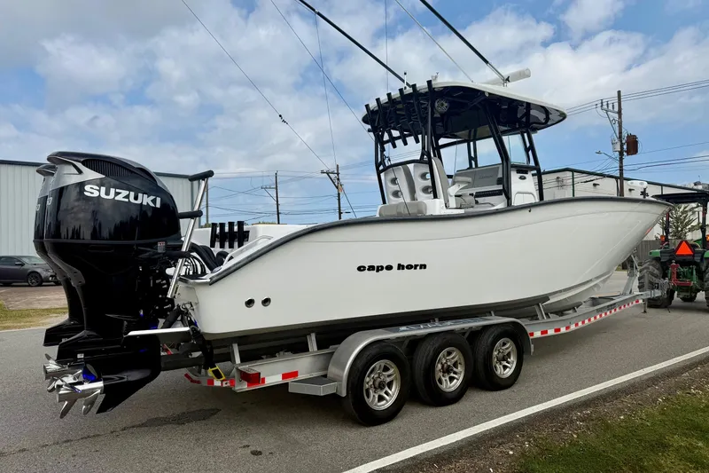 Slide: The Image of 2022 Cape Horn 31 T boat cruising on water with dual Suzuki engines. - 4