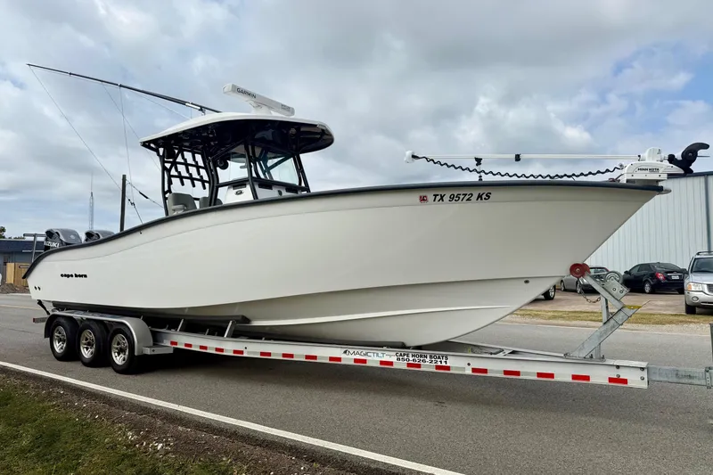 Slide: The Image of 2022 Cape Horn 31 T boat on calm water, featuring Garmin equipment. - 5