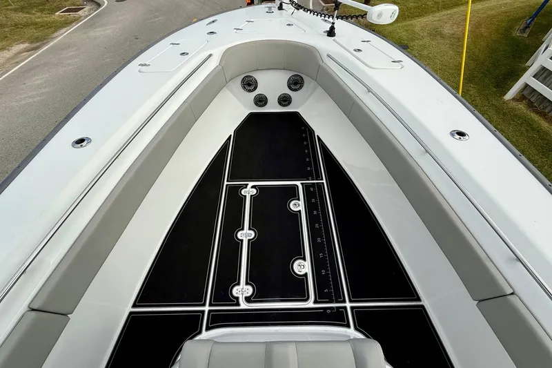 Slide: The Image of 2022 Cape Horn 31 T boat with seating and rod holders, parked on a street. - 13