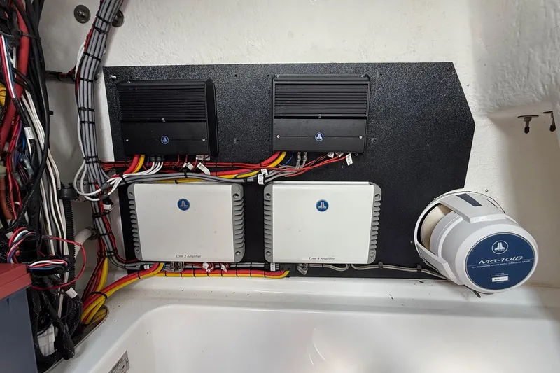 Slide: The Image of Electrical setup in a 2022 Cape Horn 31 T boat, featuring amplifiers and wiring. - 26