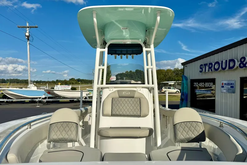 Slide: The Image of 2026 Key West 203 FS boat with seating, displayed at a dealership under a clear sky. - 11