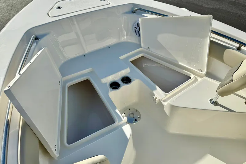 Slide: The Image of 2026 Key West 203 FS boat interior with open storage compartments and seating. - 16