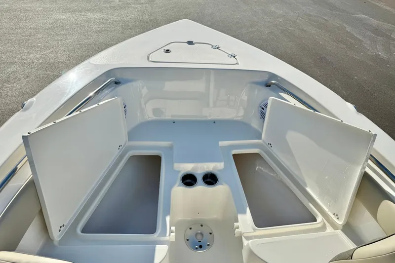 Slide: The Image of 2026 Key West 203 FS boat interior with open storage compartments and cup holders. - 17