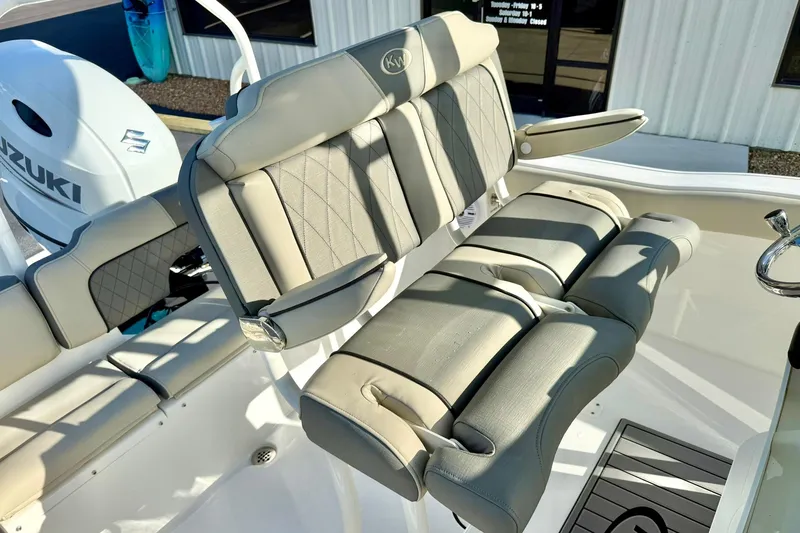 Slide: The Image of 2026 Key West 203 FS boat interior with Suzuki engine and cushioned seating. - 25
