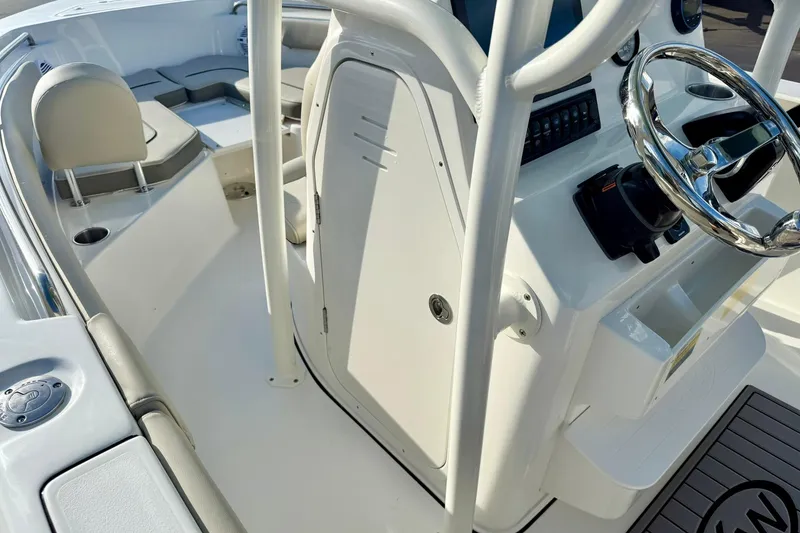 Slide: The Image of 2026 Key West 203 FS boat interior with steering wheel and seating area. - 26