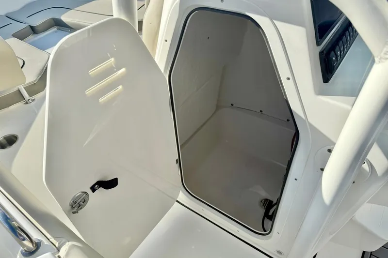 Slide: The Image of 2026 Key West 203 FS boat storage compartment with open door, showcasing interior space. - 27