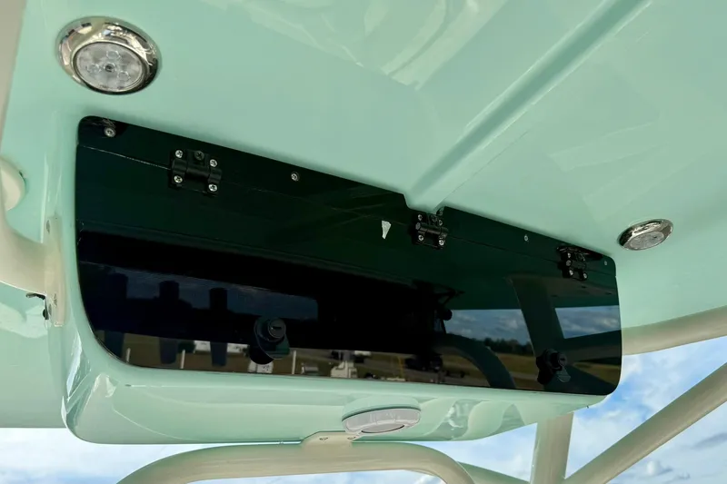 Slide: The Image of 2026 Key West 203 FS boat interior detail with sleek black panel and mint green finish. - 29