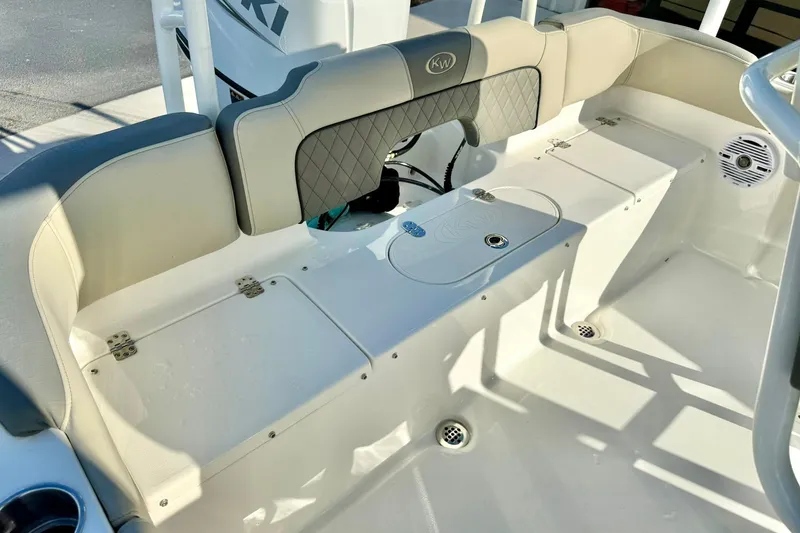 Slide: The Image of 2026 Key West 203 FS boat interior with cushioned seating and storage compartments. - 31