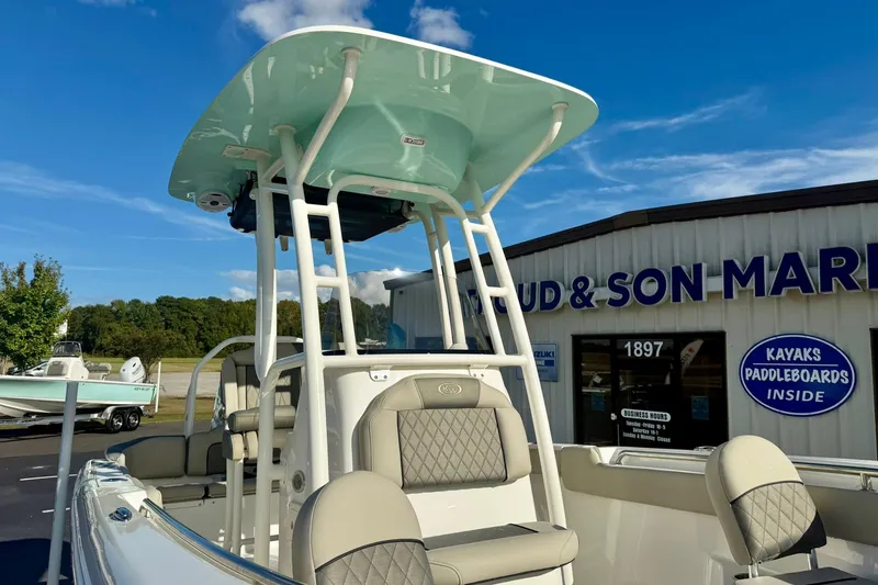 Slide: The Image of 2026 Key West 203 FS boat displayed outside a marine store under clear blue skies. - 35