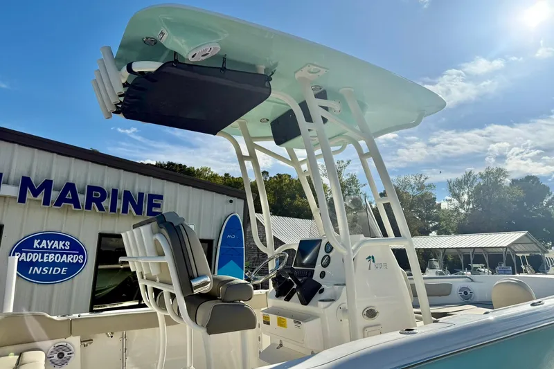 Slide: The Image of 2026 Key West 203 FS boat at a marine dealership under a clear sky. - 36