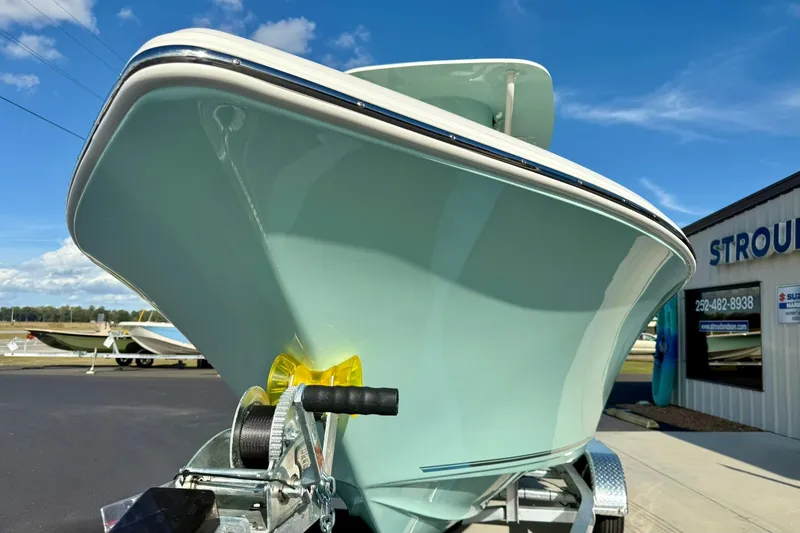 Slide: The Image of 2026 Key West 203 FS boat on trailer, displayed outdoors under clear blue sky. - 8