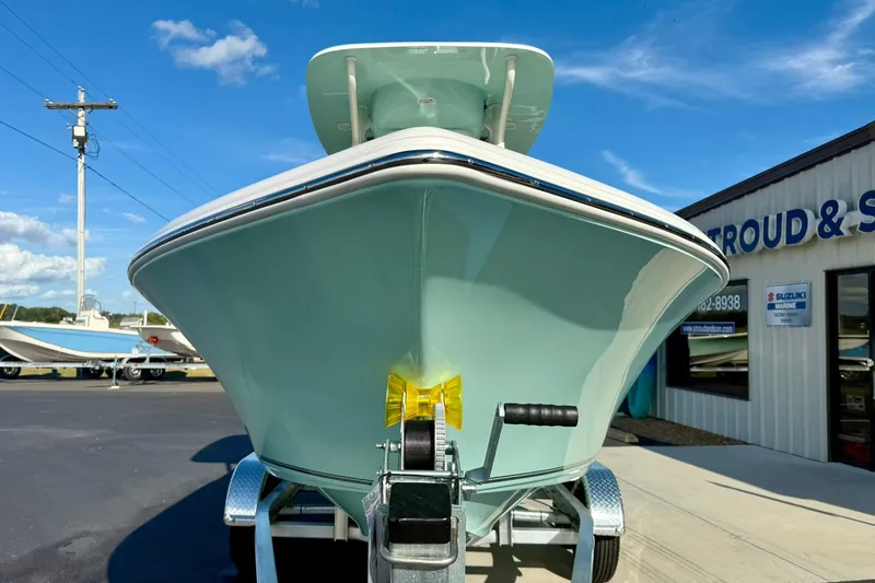 Slide: The Image of 2026 Key West 203 FS boat on trailer outside dealership under blue sky. - 9