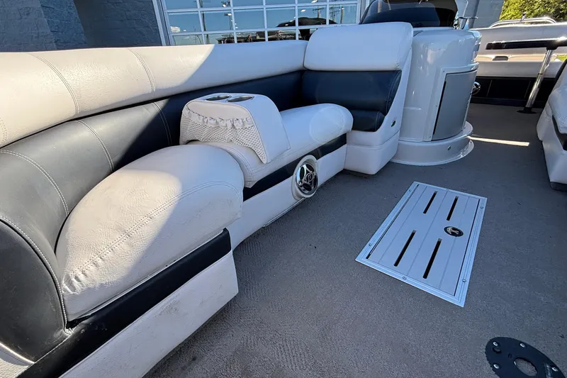 Slide: The Image of 2010 Premier 250 Grand Isle boat interior with plush seating and cup holders. - 11