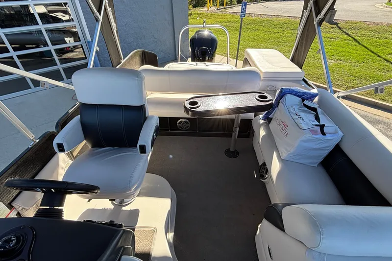 Slide: The Image of Interior of a 2010 Premier 250 Grand Isle boat with seating and table. - 14