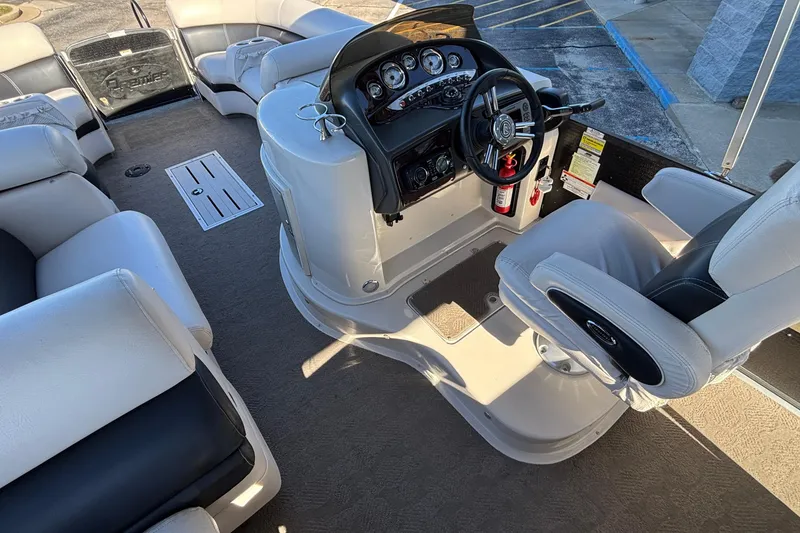 Slide: The Image of Interior of a 2010 Premier 250 Grand Isle boat with steering console and seating. - 16