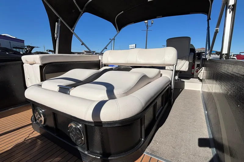 Slide: The Image of 2010 Premier 250 Grand Isle boat interior with cushioned seating and canopy. - 6