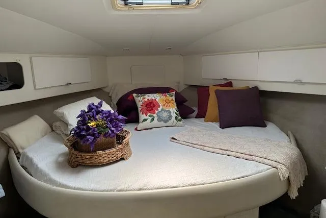Slide: The Image of 1993 Silverton Express cabin with cozy bed, decorative pillows, and floral basket. - 5