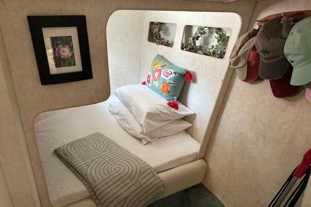 Slide: The Image of Cozy bedroom in 1993 Silverton Express boat with decorative pillows and wall art. - 6
