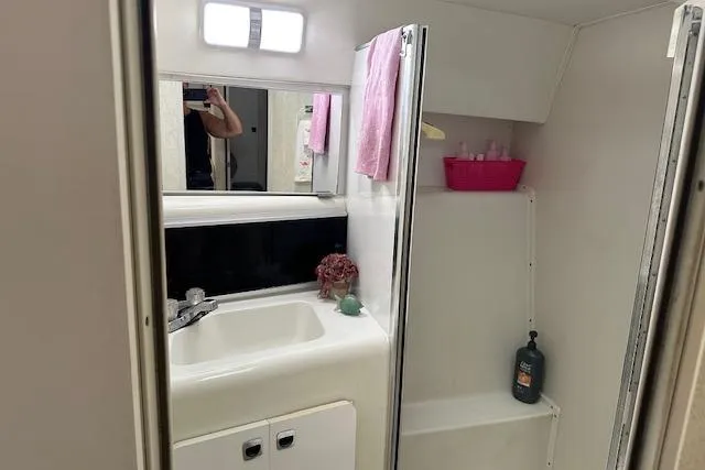 Slide: The Image of 1993 Silverton Express bathroom with sink, mirror, and shower area. - 7