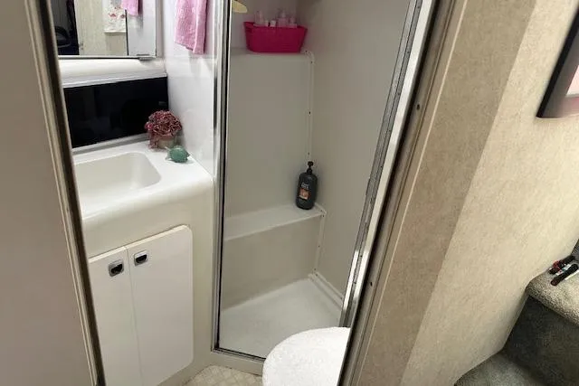 Slide: The Image of 1993 Silverton Express bathroom with shower, sink, and storage cabinet. - 8