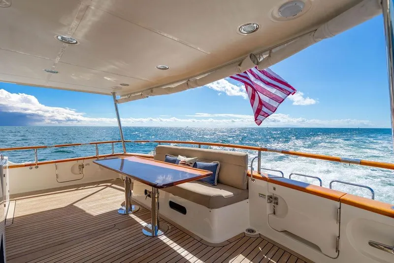 Slide: The Image of Luxurious 2015 Marlow 66E-CB yacht deck with ocean view and American flag. - 1