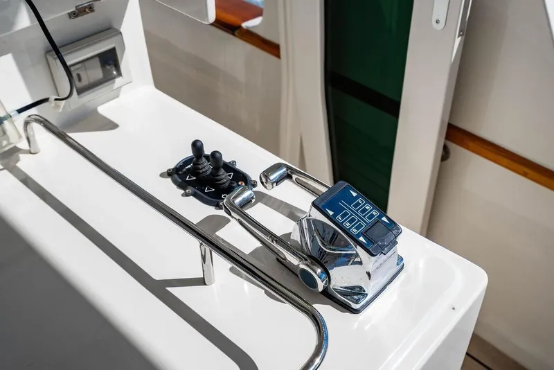 Slide: The Image of Control panel of a 2015 Marlow 66E-CB yacht, featuring joystick and throttle levers. - 11