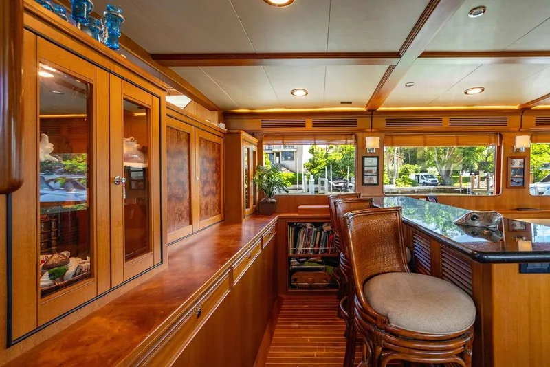 Slide: The Image of Luxurious interior of 2015 Marlow 66E-CB yacht with wooden cabinetry and bar seating. - 16