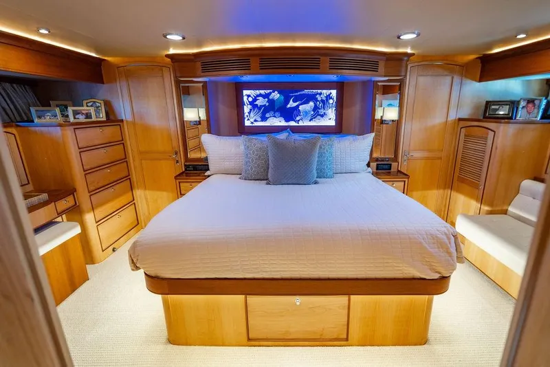 Slide: The Image of Luxurious bedroom in a 2015 Marlow 66E-CB yacht with elegant wood finishes. - 21