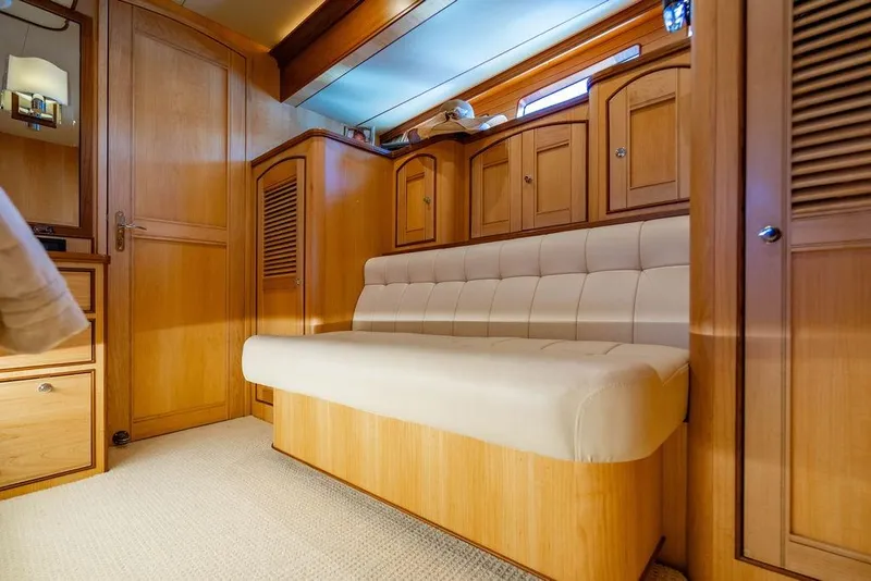 Slide: The Image of Luxurious wooden interior of 2015 Marlow 66E-CB yacht with cushioned seating. - 24