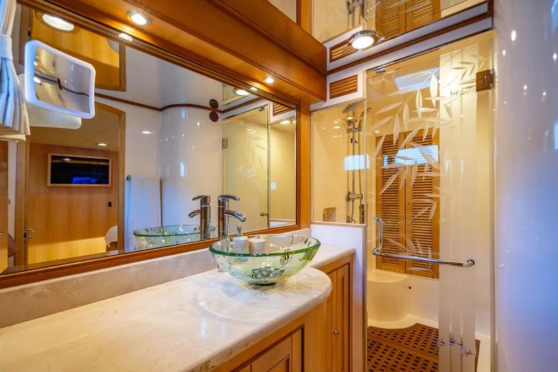 Slide: The Image of Luxurious Marlow 66E-CB 2015 yacht bathroom with glass sink and elegant shower design. - 25