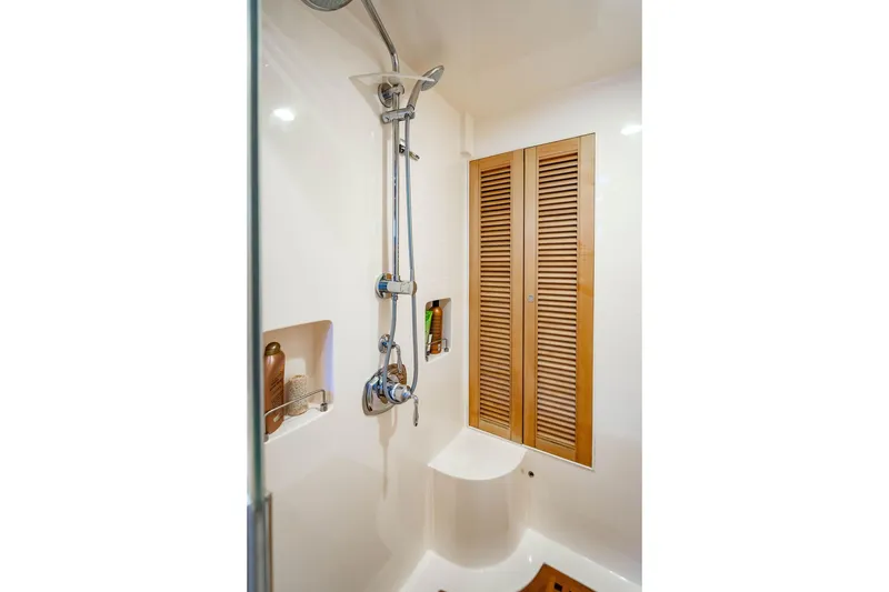 Slide: The Image of Luxurious shower area in 2015 Marlow 66E-CB yacht with wooden accents and modern fixtures. - 26