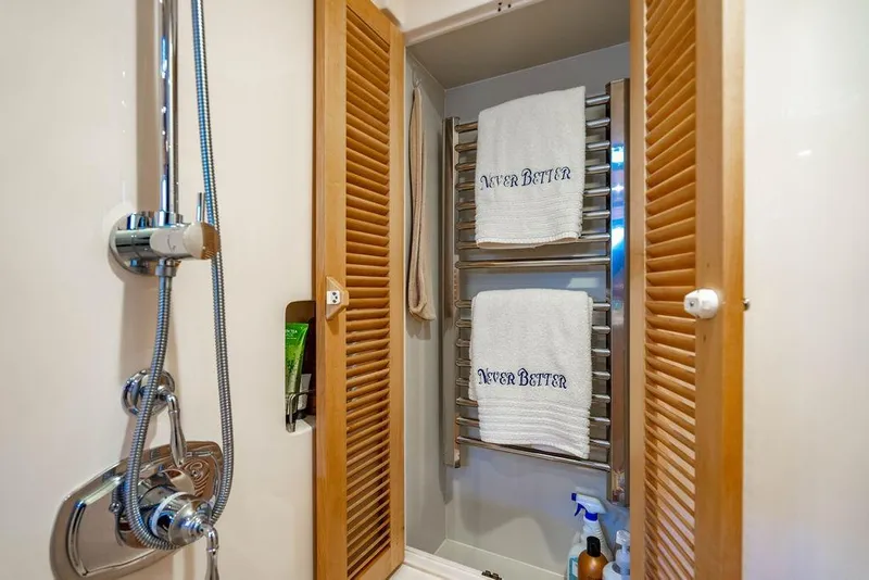 Slide: The Image of Bathroom with shower, wooden louvered doors, and towel rack on Marlow 66E-CB yacht. - 27