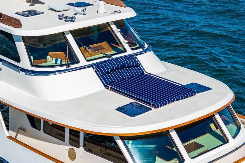 Slide: The Image of Luxury Marlow 66E-CB yacht, 2015 model, with striped sunbed on deck, cruising on blue water. - 3