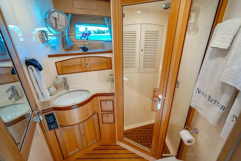 Slide: The Image of Luxurious Marlow 66E-CB 2015 yacht bathroom with wooden cabinetry and elegant fixtures. - 31