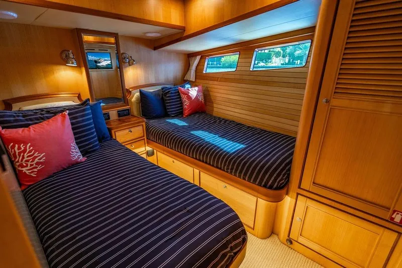 Slide: The Image of Luxurious cabin interior of 2015 Marlow 66E-CB yacht with twin beds and elegant wood finish. - 32