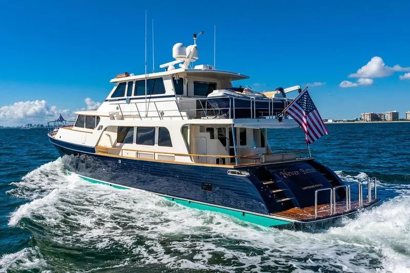 Slide: The Image of Luxurious 2015 Marlow 66E-CB yacht cruising on open water under clear blue skies. - 4