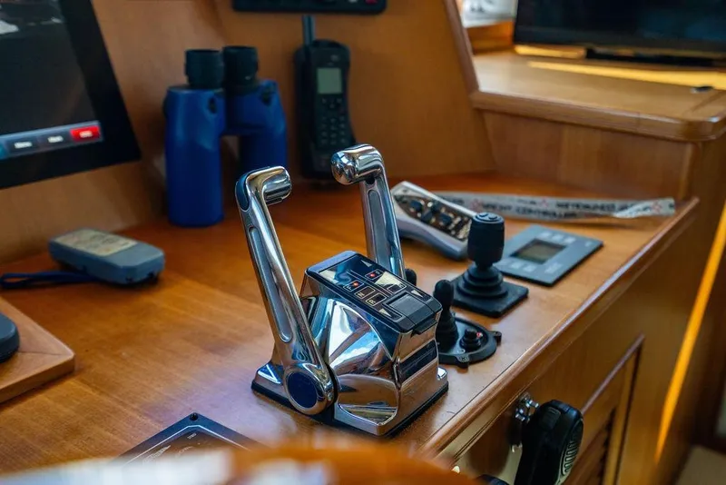 Slide: The Image of Control panel of a 2015 Marlow 66E-CB yacht with throttle levers and navigation equipment. - 41