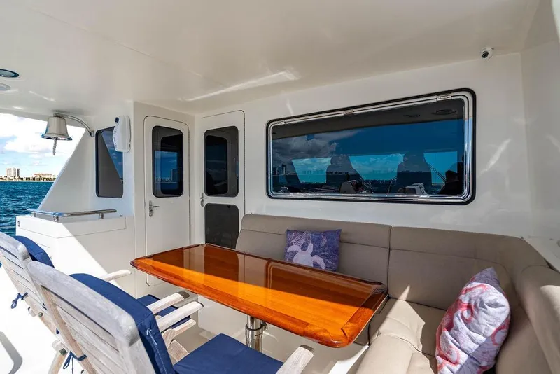 Slide: The Image of Luxurious 2015 Marlow 66E-CB yacht deck with seating and ocean view. - 44