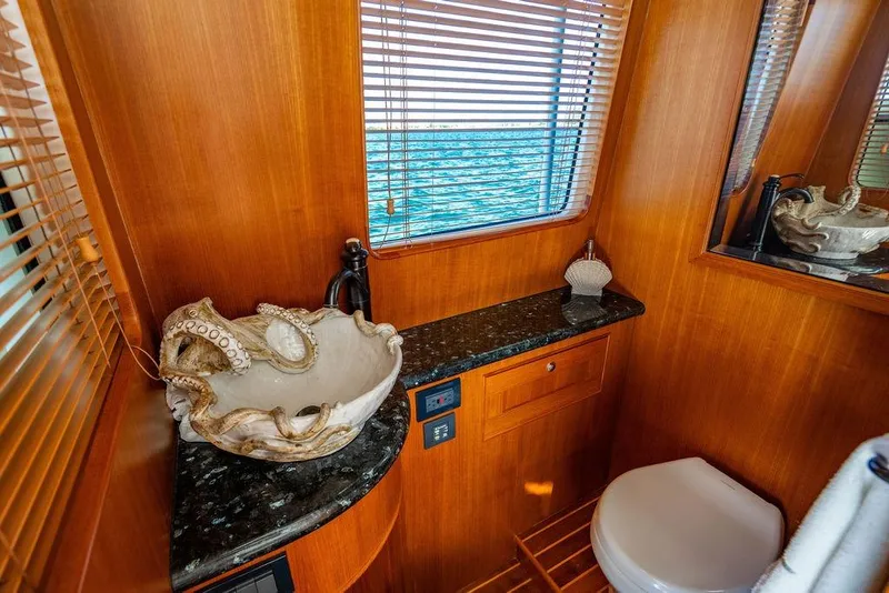 Slide: The Image of Luxurious Marlow 66E-CB 2015 yacht bathroom with elegant wood finish and unique shell sink. - 45