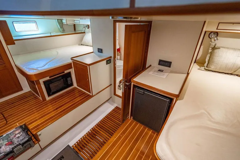 Slide: The Image of Interior of 2015 Marlow 66E-CB yacht with wooden flooring and cozy sleeping area. - 51