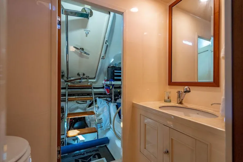 Slide: The Image of Luxurious 2015 Marlow 66E-CB yacht bathroom with sink, mirror, and engine room access. - 54