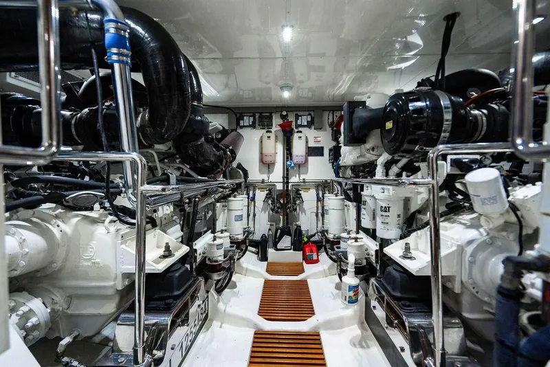 Slide: The Image of Engine room of 2015 Marlow 66E-CB yacht, featuring dual engines and mechanical components. - 55