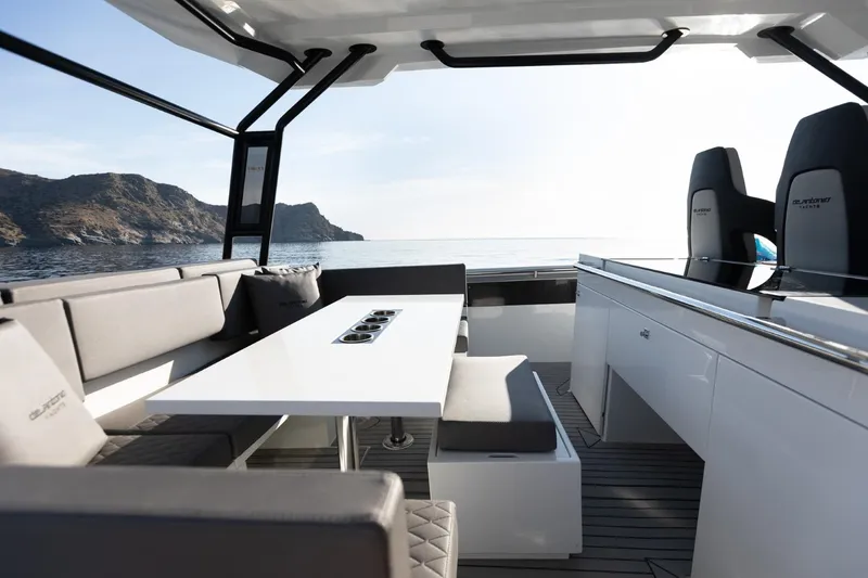 Slide: The Image of Modern 2026 De Antonio Yachts D36 interior at a boat show, featuring sleek design and seating area. - 9