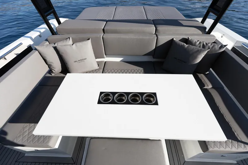 Slide: The Image of Luxurious seating area on 2026 De Antonio Yachts D36 with cushions and sleek table design. - 11
