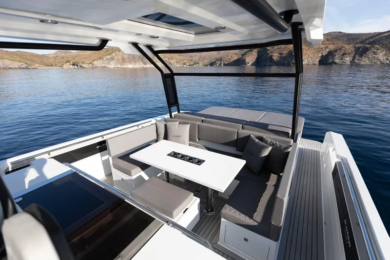 Slide: The Image of Luxurious 2026 De Antonio Yachts D36 with elegant seating, table, and scenic ocean view. - 12