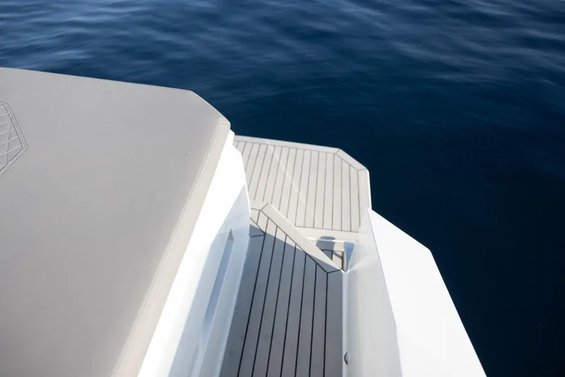 Slide: The Image of 2026 De Antonio Yachts D36 deck with sleek design on calm water. - 7