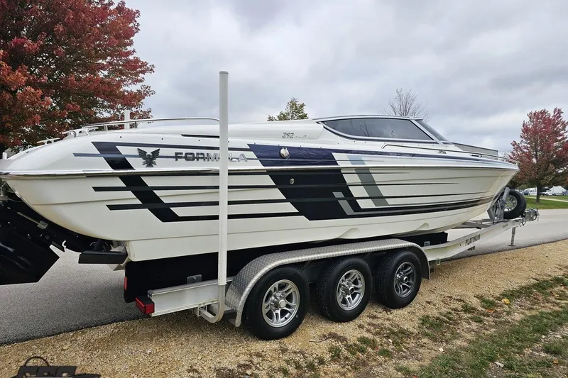 Slide: The Image of 2019 Formula 292 FASTech boat on trailer, parked outdoors under clear blue sky. - 19