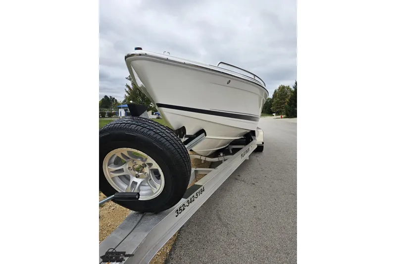 Slide: The Image of 2019 Formula 292 FASTech boat on trailer, sleek design with blue and white graphics. - 7