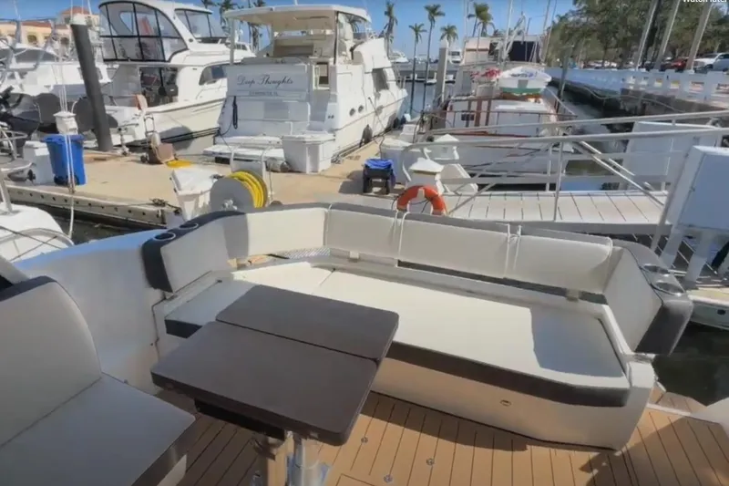 Slide: The Image of 2023 Bavaria R40 Coupe yacht interior with seating and table at marina. - 12